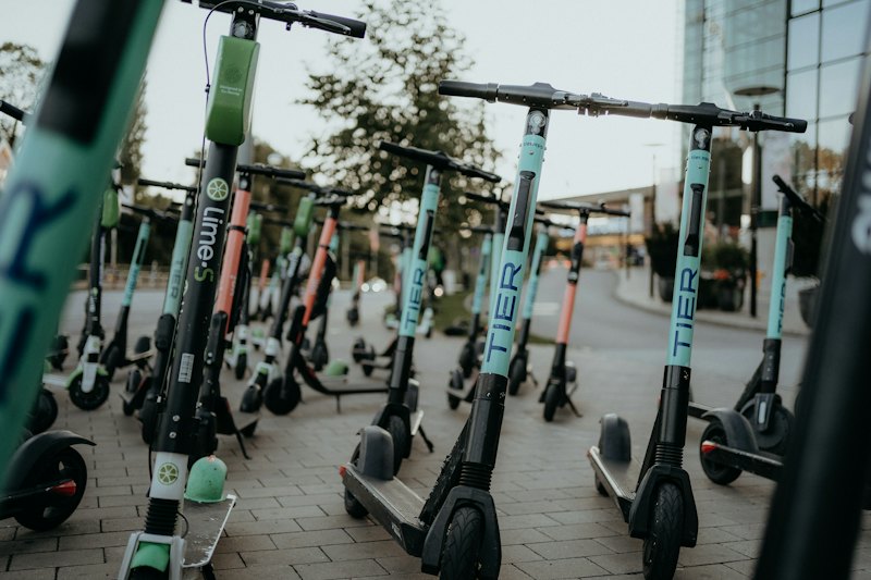 A row of rental e-scooters on the pavement